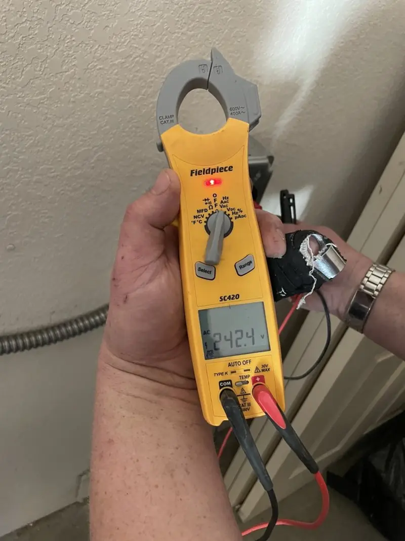 Voltage testing with clamp meter during Outlet Installation in Sheboygan Falls